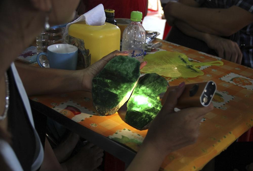 Local people examine the quality of a jade stone in the Hpakant area of Kachin state, northern Myanmar on September 18, 2015. (AP File Photo)